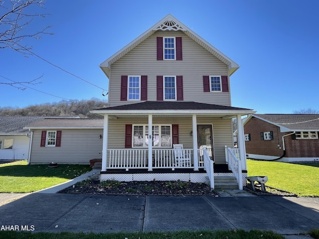 view of front of home featuring covered porch and a front yard