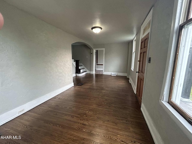 325 Mcfarland Rd, Tyrone, PA 16686 - hallway with arched walkways, dark wood-style floors, stairway, and a textured wall