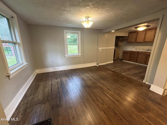 325 Mcfarland Rd, Tyrone, PA 16686 - unfurnished dining area with dark wood-type flooring, healthy amount of natural light, and a textured ceiling
