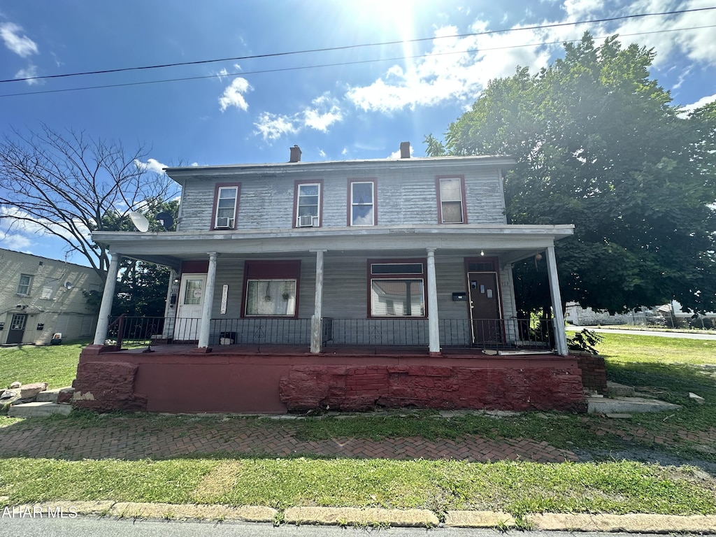 917-919 8th Ave, Altoona, PA 16602 - view of front of house with a porch, a front lawn, and a chimney