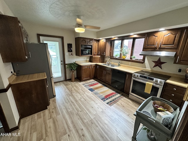 705 Clark St, Hollidaysburg, PA 16648 - kitchen featuring black appliances, light wood-style flooring, range hood, healthy amount of natural light, and a textured ceiling