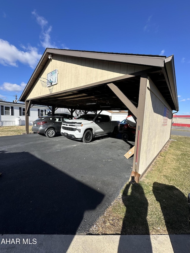 view of parking / parking lot featuring a carport