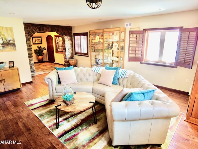 9510 Lincoln Hwy, Bedford, PA 15522 - living room with arched walkways, hardwood / wood-style flooring, and plenty of natural light