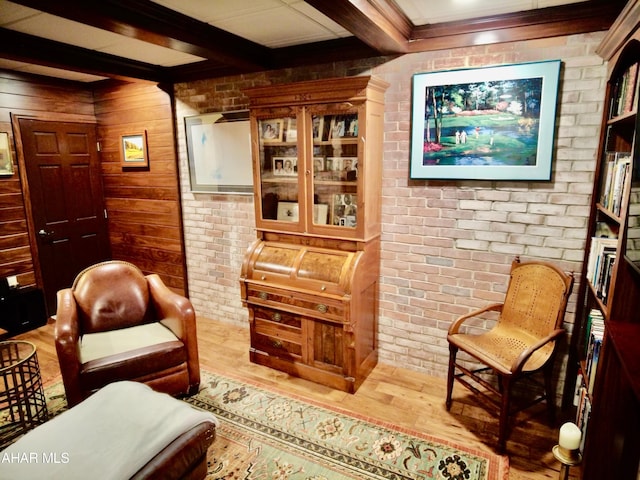 9510 Lincoln Hwy, Bedford, PA 15522 - sitting room featuring wood finished floors, beamed ceiling, wooden walls, and brick wall