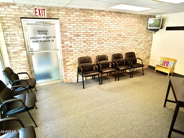 9510 Lincoln Hwy, Bedford, PA 15522 - interior space with a paneled ceiling, carpet, and brick wall