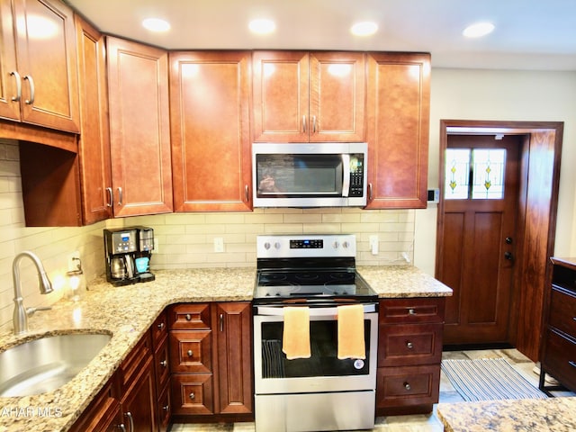 9510 Lincoln Hwy, Bedford, PA 15522 - kitchen with appliances with stainless steel finishes, light stone counters, tasteful backsplash, recessed lighting, and reddish brown cabinets