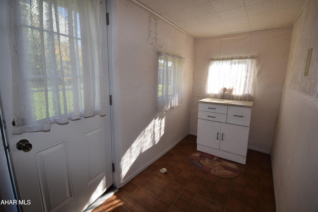 doorway to outside featuring dark tile patterned floors