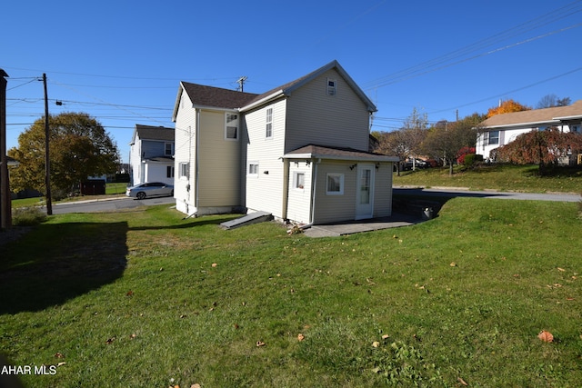 back of house with a lawn