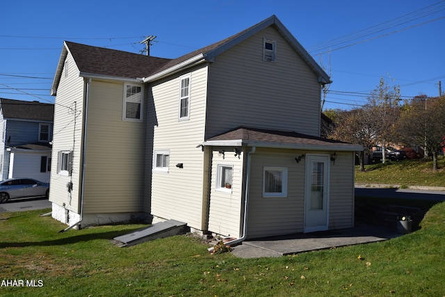 back of property featuring a yard