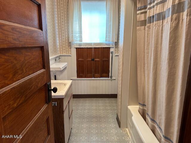 bathroom featuring vanity and shower / tub combo with curtain