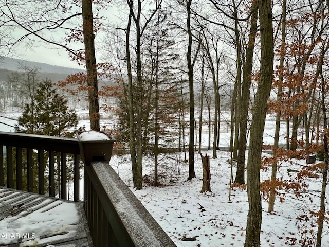 snow covered deck featuring a mountain view