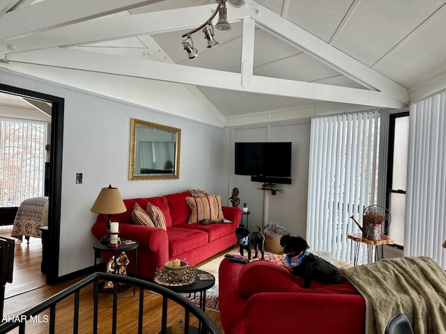 living room featuring vaulted ceiling with beams and wood-type flooring