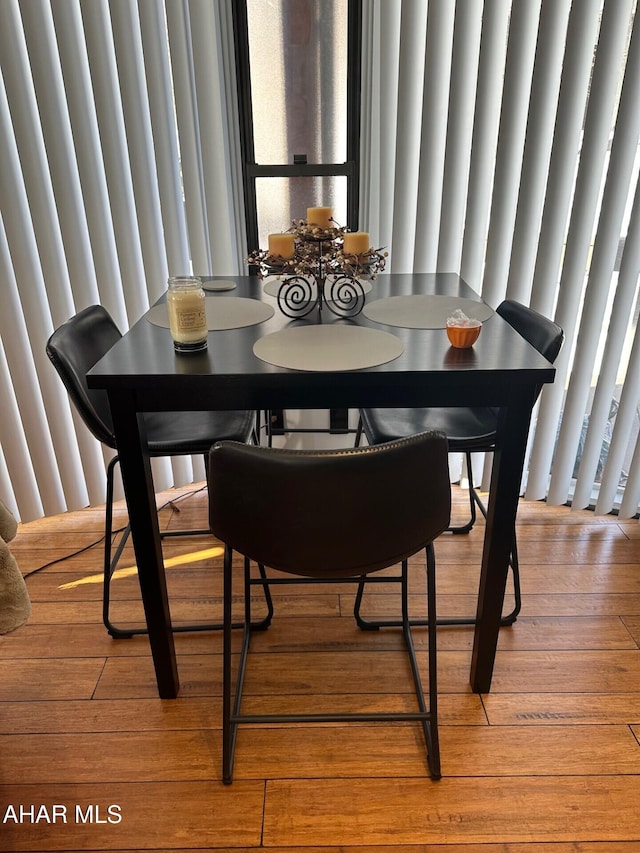 dining room with a wealth of natural light and hardwood / wood-style flooring