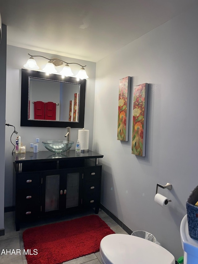 bathroom featuring tile patterned floors, vanity, and toilet