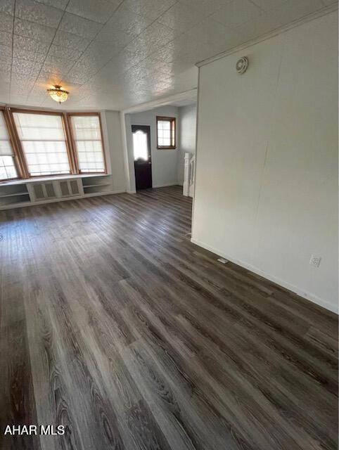 unfurnished living room with dark hardwood / wood-style floors