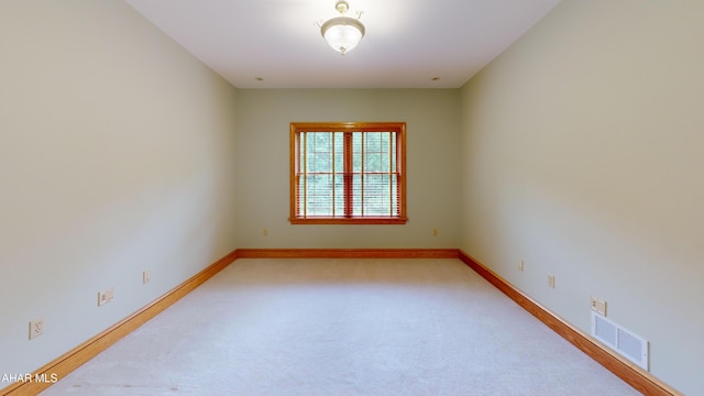 spare room with baseboards and carpet flooring
