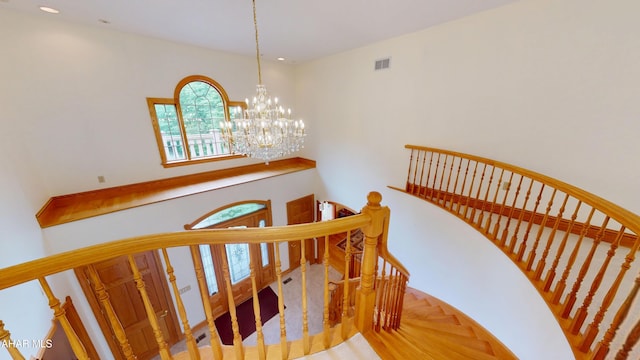 staircase with a chandelier and recessed lighting
