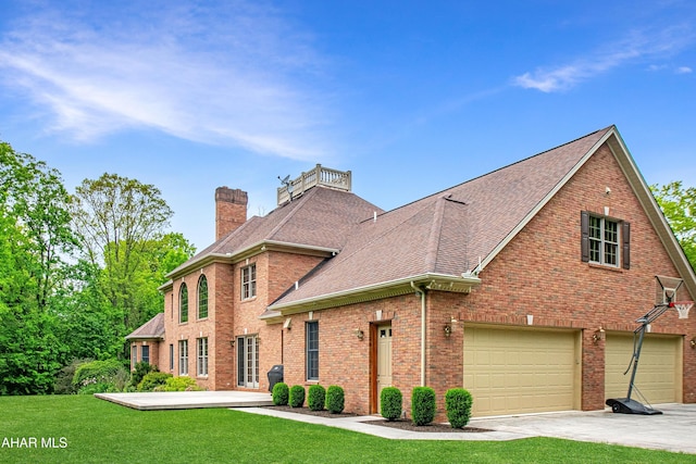 view of front of house featuring a chimney, a garage, roof with shingles, a front yard, and brick siding