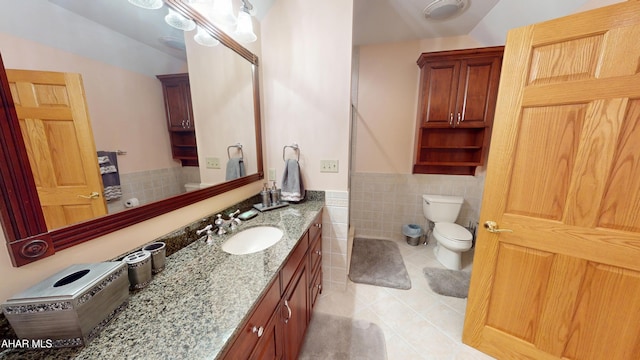 full bathroom with toilet, tile patterned floors, lofted ceiling, tile walls, and vanity