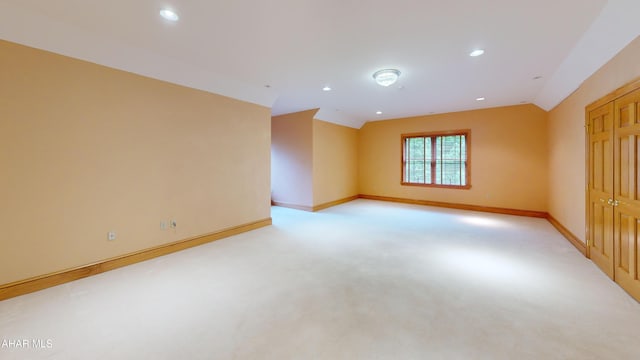 unfurnished room featuring light carpet, baseboards, recessed lighting, and vaulted ceiling
