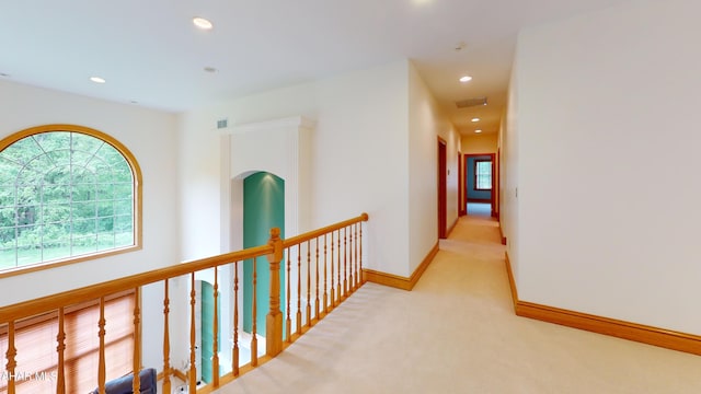 hallway with light colored carpet, recessed lighting, and baseboards