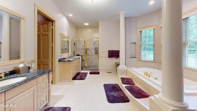full bathroom featuring healthy amount of natural light, a bath, two vanities, a stall shower, and recessed lighting