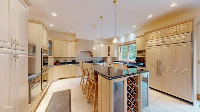 kitchen with a kitchen breakfast bar, a warming drawer, glass insert cabinets, stainless steel appliances, and hanging light fixtures