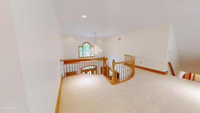 corridor with an upstairs landing, a chandelier, carpet floors, recessed lighting, and baseboards