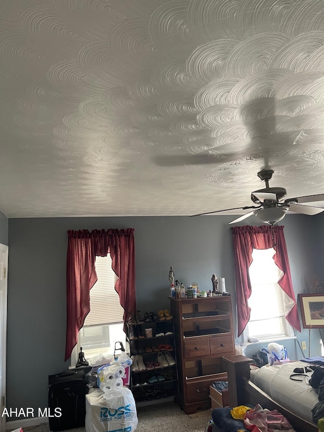 carpeted bedroom with ceiling fan