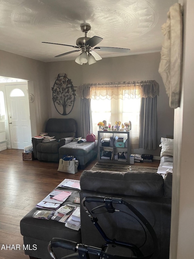 living room with ceiling fan, a textured ceiling, and hardwood / wood-style flooring