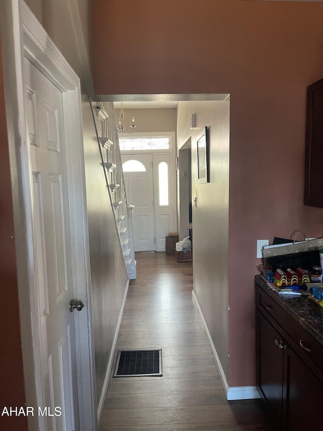 interior space featuring hardwood / wood-style floors and an inviting chandelier