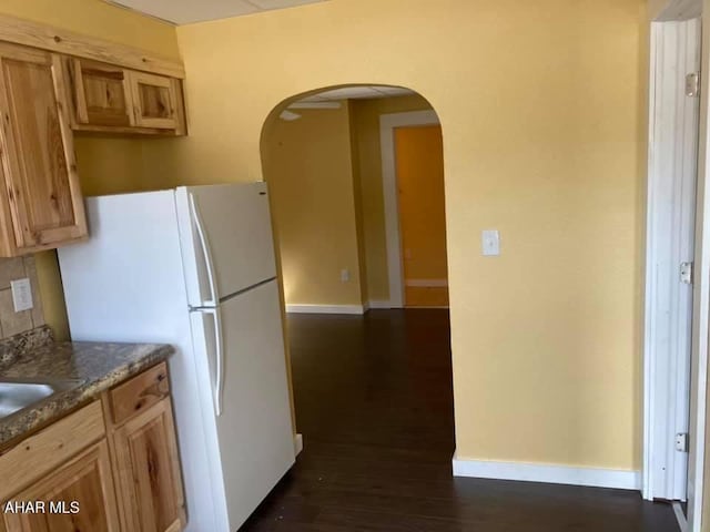 kitchen with dark hardwood / wood-style floors and white fridge