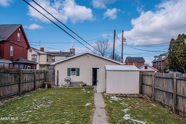 rear view of house with a storage unit and a yard