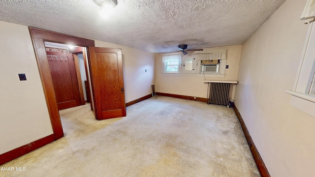 interior space featuring a textured ceiling, radiator heating unit, electric panel, cooling unit, and light colored carpet