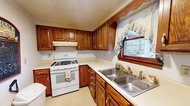 kitchen featuring white gas range and sink