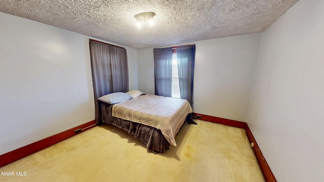 bedroom with carpet floors and a textured ceiling