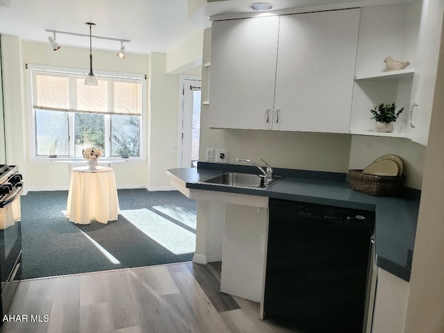 kitchen with black appliances, white cabinets, sink, hanging light fixtures, and light wood-type flooring