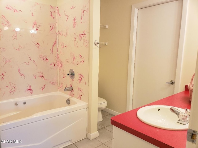 bathroom featuring tile patterned floors, a tub to relax in, vanity, and toilet