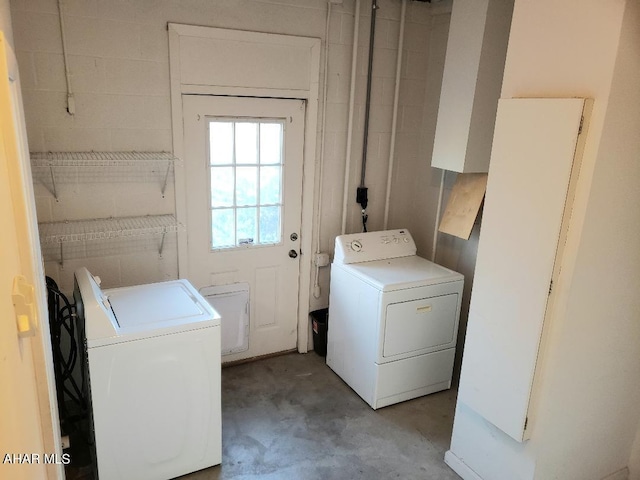 clothes washing area with washing machine and clothes dryer