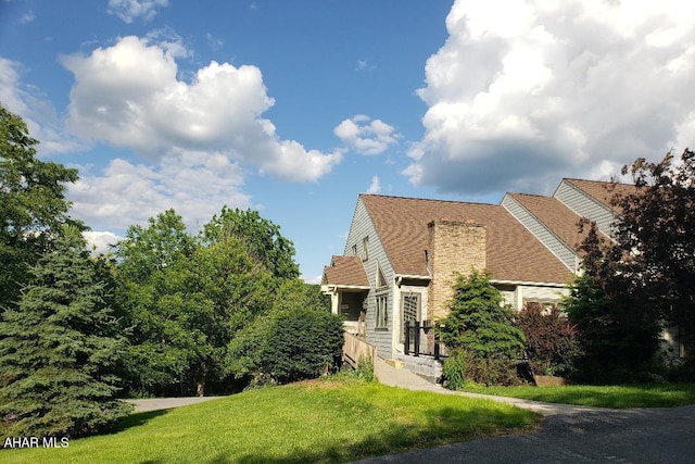 view of side of home with a yard