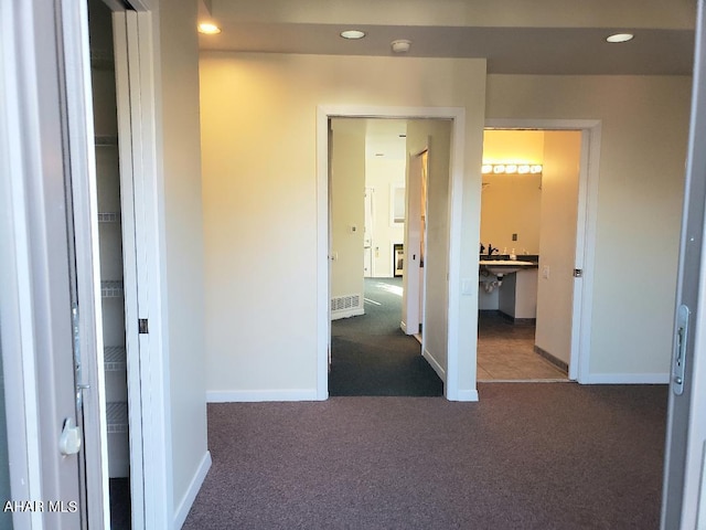 hallway with recessed lighting, baseboards, and carpet floors