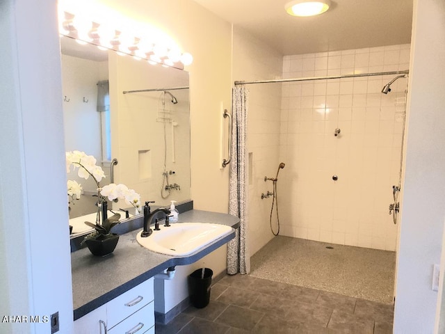 bathroom with a shower with curtain, sink, and tile patterned flooring