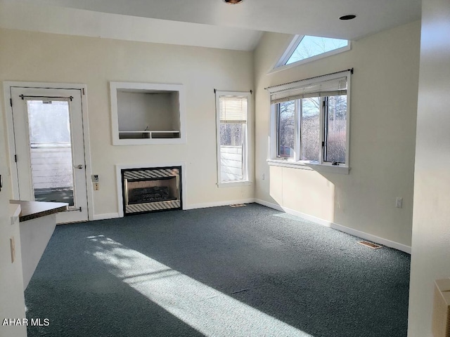 unfurnished living room with carpet flooring and lofted ceiling