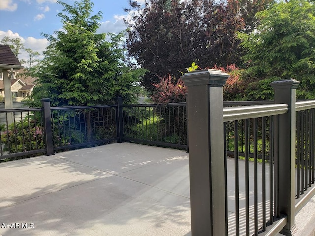 view of gate featuring a patio and fence