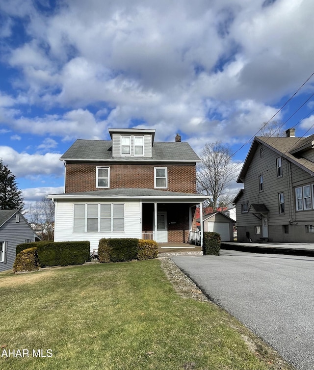 view of front property with covered porch and a front lawn