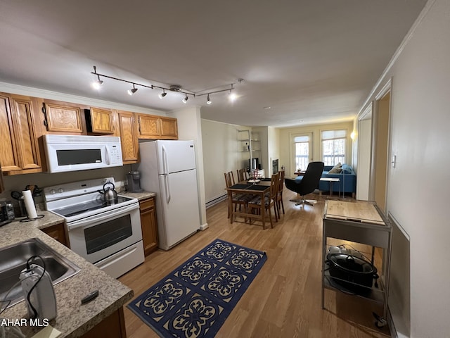 kitchen with white appliances, crown molding, sink, a baseboard radiator, and light hardwood / wood-style floors