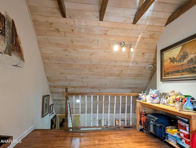 additional living space with lofted ceiling with beams, wood-type flooring, and wood ceiling