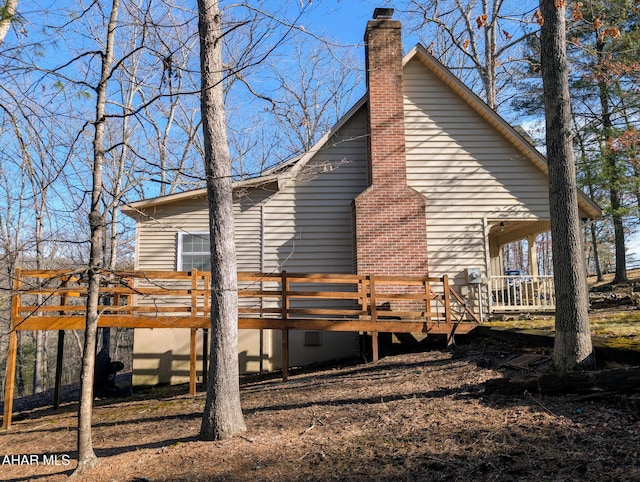 view of side of home with a wooden deck