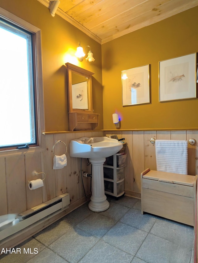 bathroom featuring crown molding, a baseboard heating unit, wooden ceiling, and wooden walls