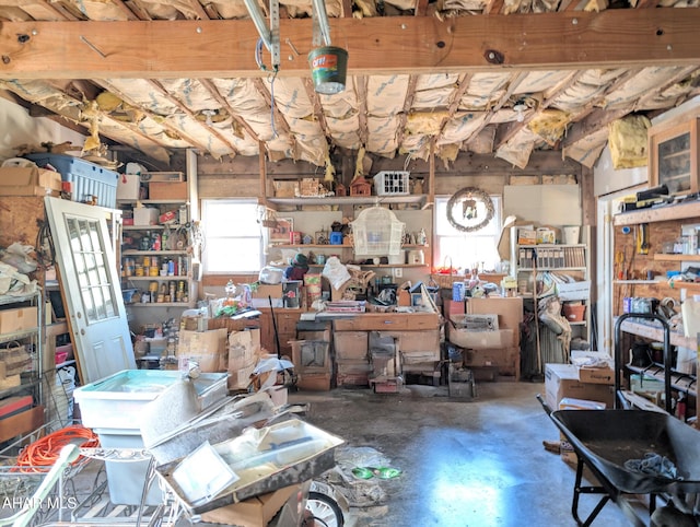 miscellaneous room with concrete flooring and a workshop area